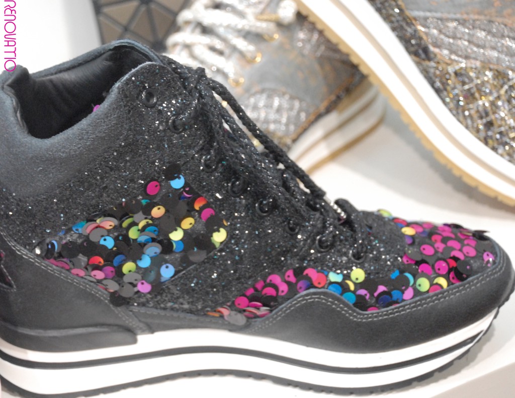 IL TACCO. 2STARGOLD. Revolutionary high black leather sneaker in vintage effect and multicolored sequined decoration. Black purplish is embedded. With overlayed stars in the heel. Black rolled cords with nickel metallic tip. Black and ivory white bicolor rubber sole with rubber around the heel. Ergonomic insole covered by a 4.5 cm wedge made of calf leather.