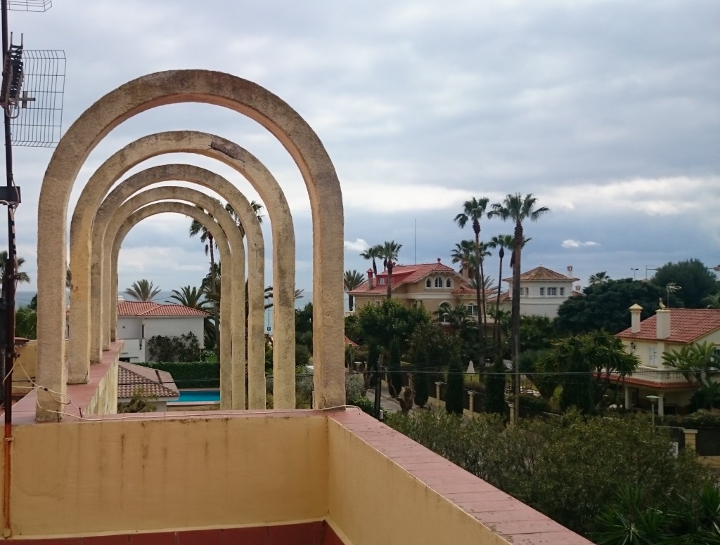 Looking out to the sea from the round arch at the roof terrace, Villa Concepción & Villa Isla Cozumel can be spotted rising up majestically.